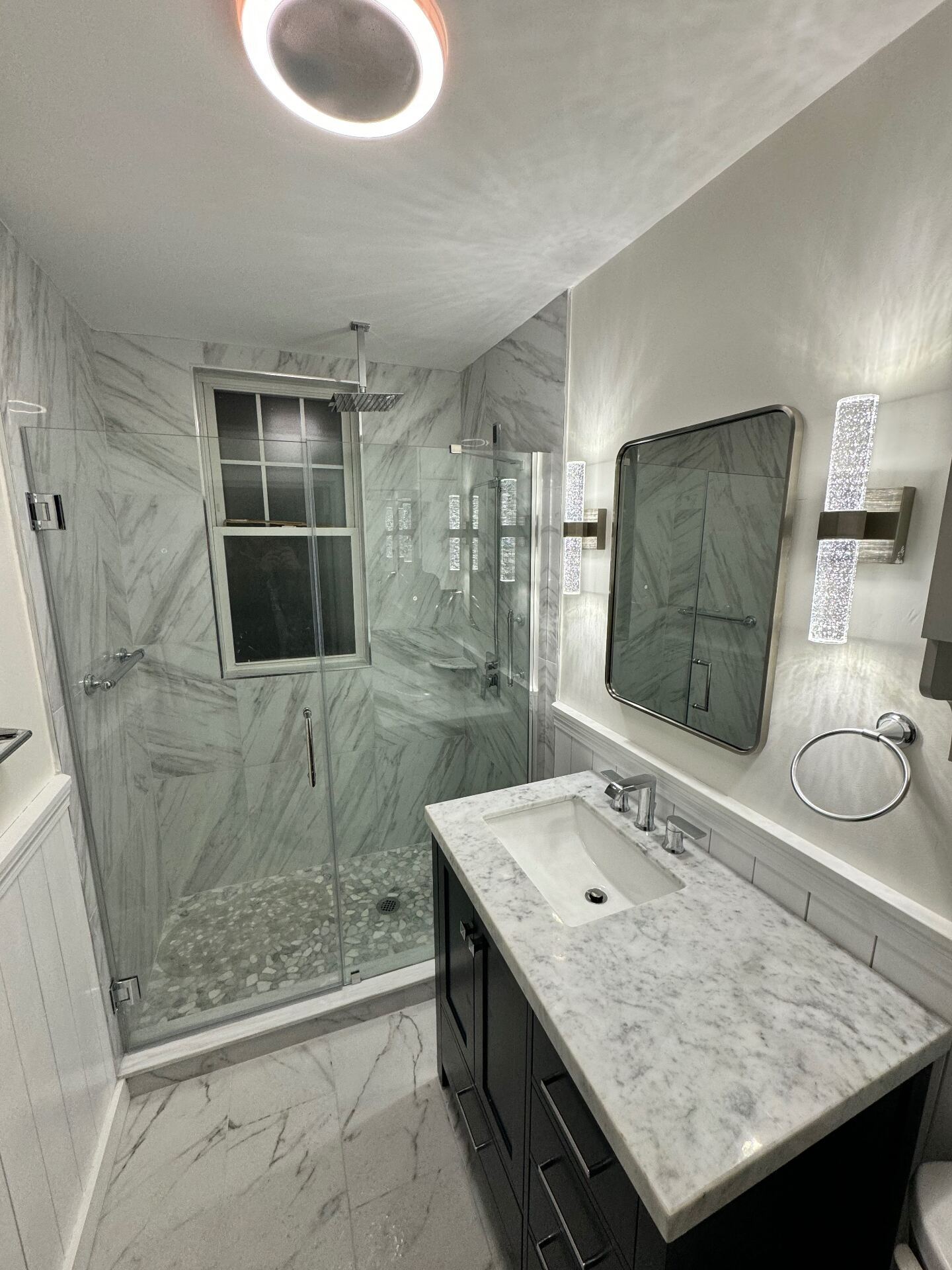 Marble shower with glass enclosure