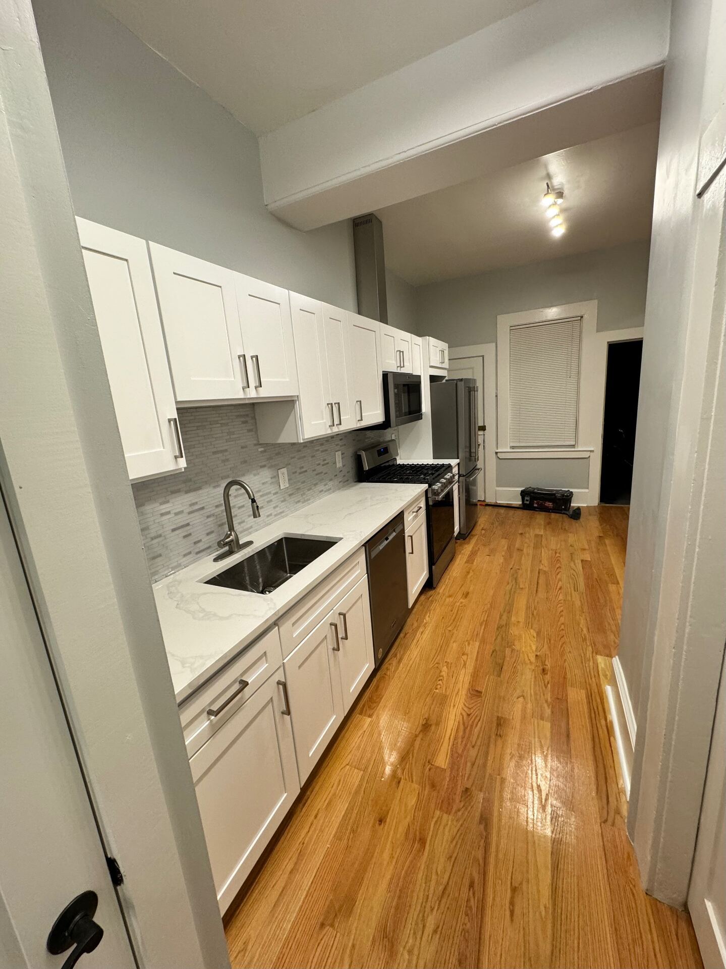 White shaker kitchen with hardwood floors