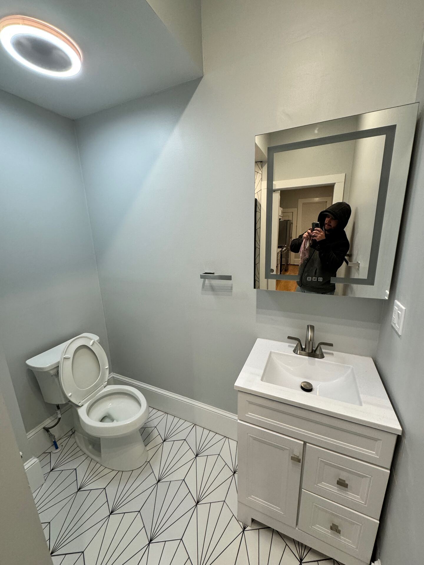 Modern powder room with patterned tile floor
