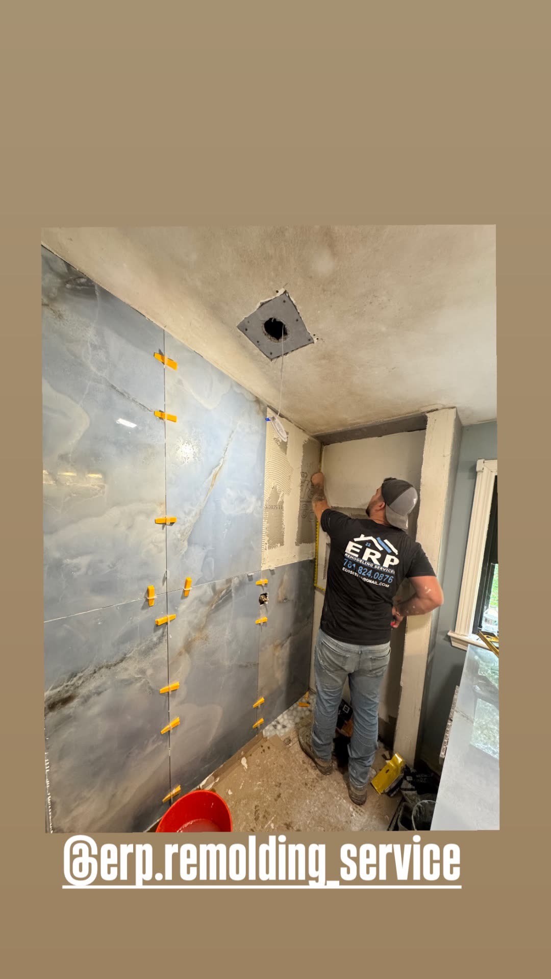 Blue onyx marble large-format tile shower install in progress