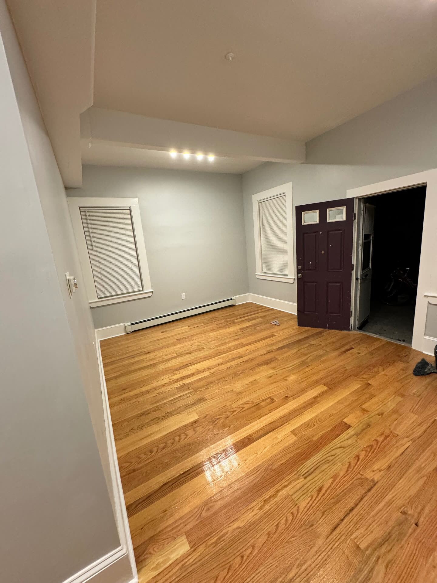 Refinished red oak hardwood floors in a freshly painted living room